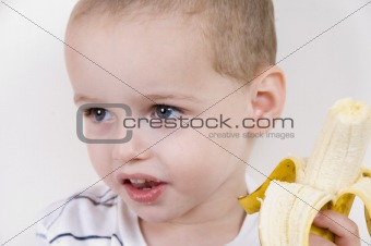 little boy with peeled banana