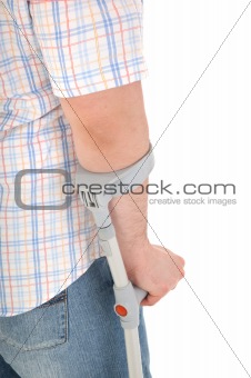man walking with a crutch against white background