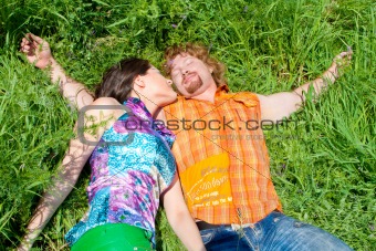 Couple sleeping in grass