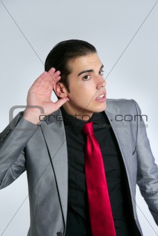 Businessman with hand in ear as a deafness sign