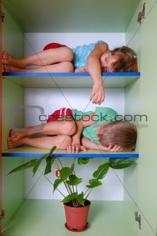 tired kids in a closet