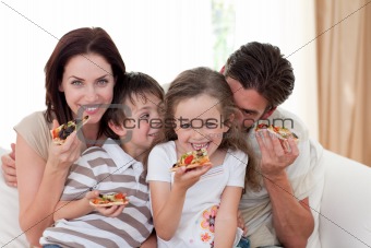 Smiling family eating pizza 