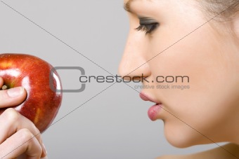 woman looking at an apple