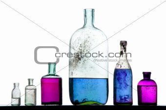 colorful liquid on antique bottles