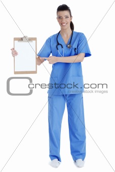 Full length of young nurse pointing blank clipboard
