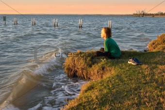 boy looking over lake