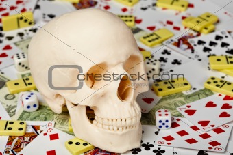 Skull on playing cards and money