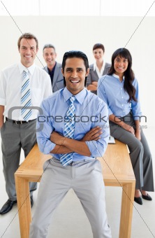 Cheerful International Business partners standing around a table