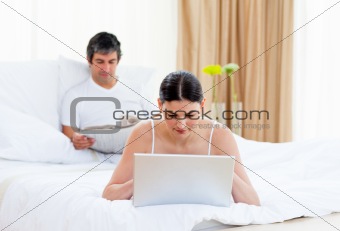 Caucasian couple relaxing on their bed 