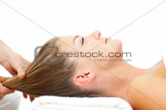 Relaxed woman enjoying a hair massage