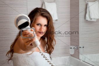 attractive woman using fen in bathroom
