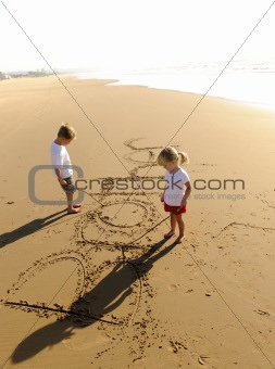 Kids writing in sand