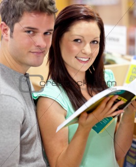 Caucasian couple looking for a book