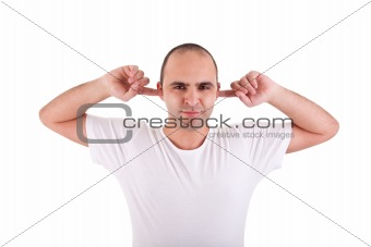Young man, holding fingers in his ears, protecting himself from noise