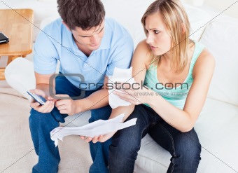 Caucasian couple making calculation