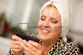 Attractive Woman Texting With Her Cell Phone with Narrow Depth of Field.