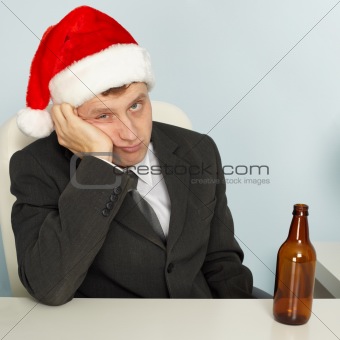 Sad man suffering from hangover after Christmas