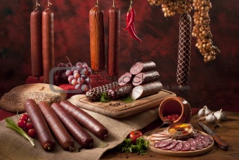 A composition of different sorts of sausages on the table
