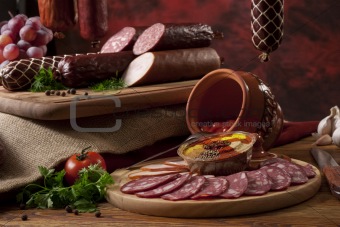 A composition of different sorts of sausages on the table
