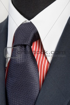 blue suit with tie and red striped shirt