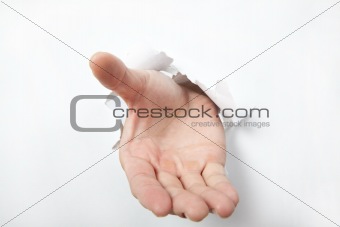 Hand punching through white  paper and try to shake or take some one