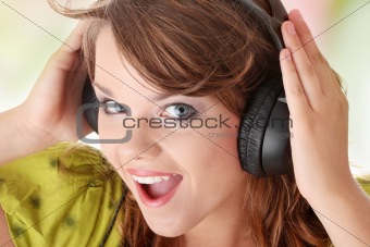 Beautiful teenage girl listening to music