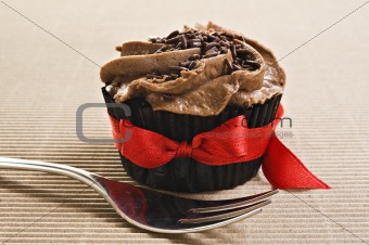 Cup cake with red bow and fork