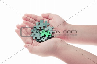 Hands holding pieces of jigsaw puzzle 