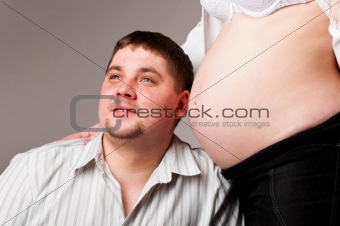 man is trying to listen his baby