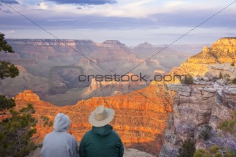 Couple Enjoying the Beautiful Landscape of the Grand Canyon Sunset.