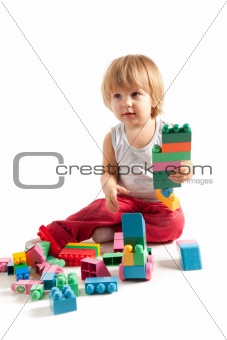 Funny boy playing with blocks 