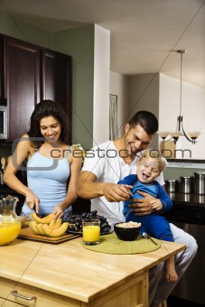 Family in kitchen.