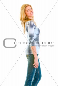 Portrait of smiling beautiful teen girl standing profile
