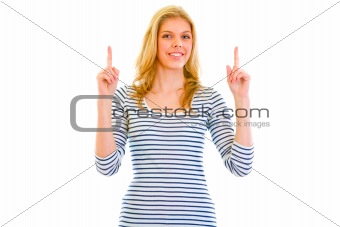 Smiling beautiful teen girl  pointing finger up
