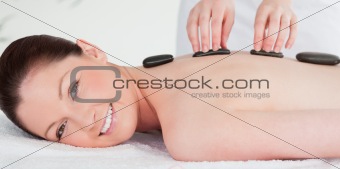 Smiling woman receiving a hot stone massage