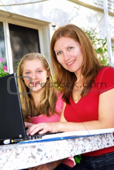 Mother and daughter with computer