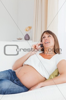 Portrait of a happy pregnant woman phoning