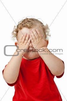 Baby girl covering her eyes with her hands playing peek-a-boo isolated on white