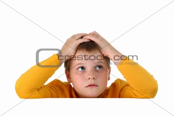 Small hopeless boy holding his head with both hands resting arms on blank whiteboard isolated on white