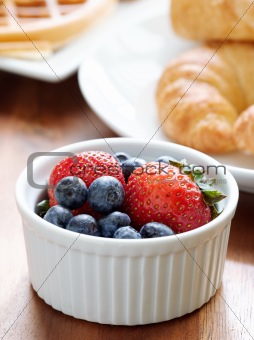 breakfast setting with blueberries and strawberries.