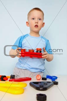 Kid plays with toy parts