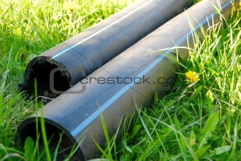 construction pipes lying on the grass during contruction
