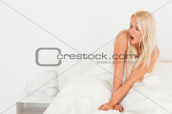 Blonde woman yawning