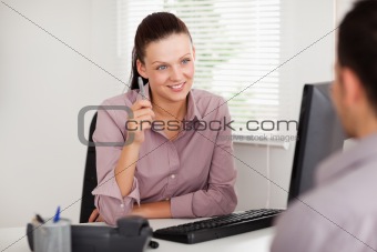 Businesswoman listening to customer