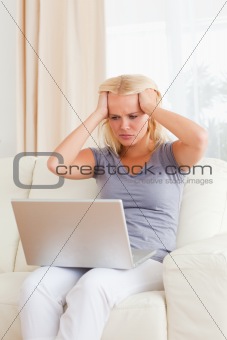 Portrait of an unhappy woman with a laptop