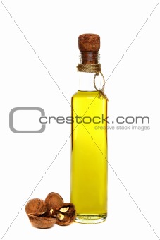Walnut oil in a bottle on a white background.