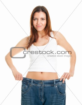 Slim woman pulling oversized jeans