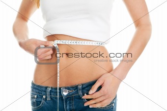 Beautiful woman measuring waist