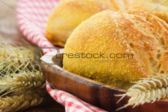Freshly baked bread variety on wooden background