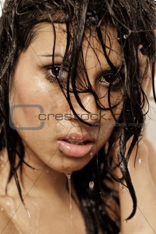 Dark hair beauty in shower face shot